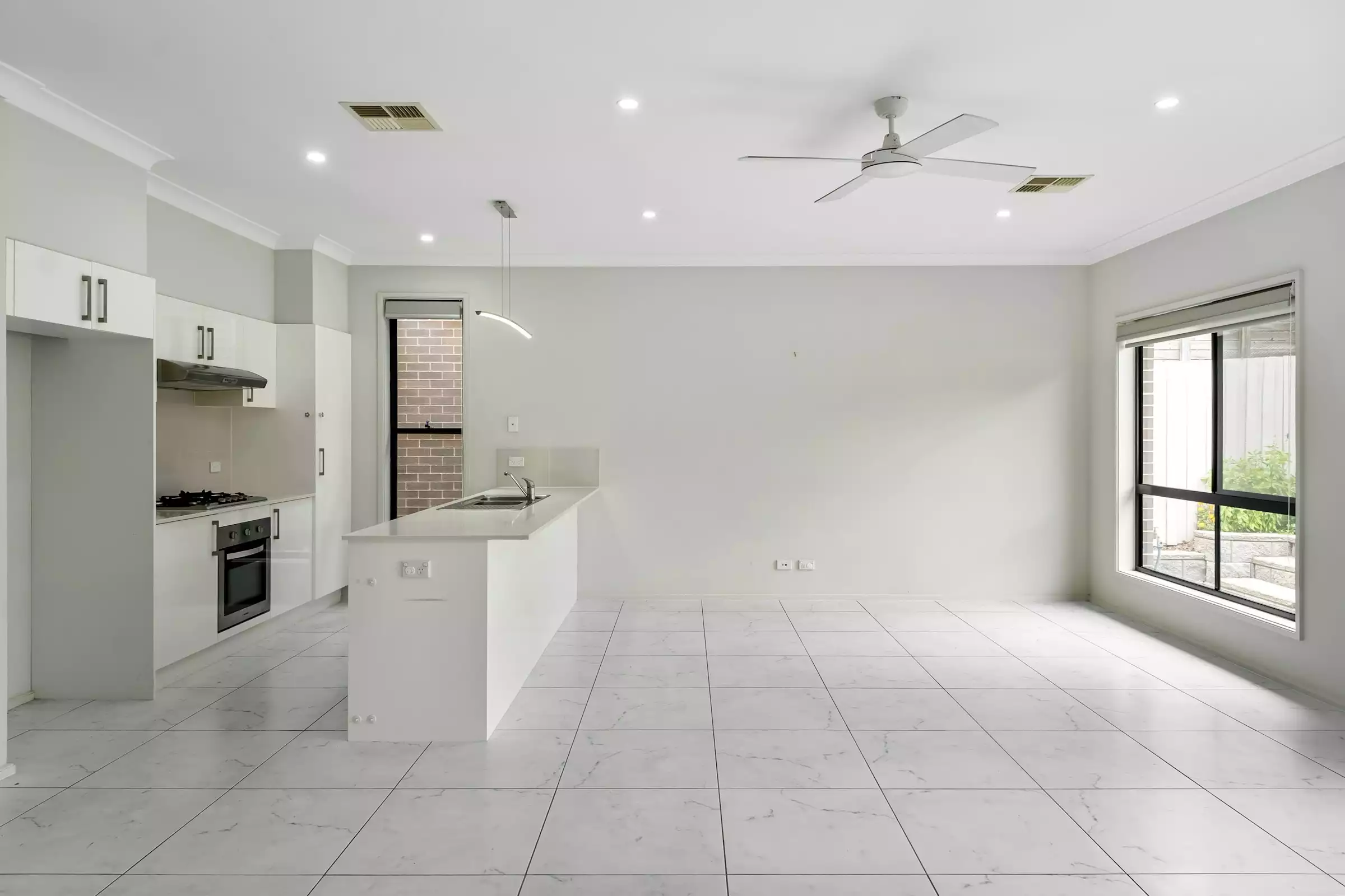 Empty modern open plan living room and kitchen before virtual staging