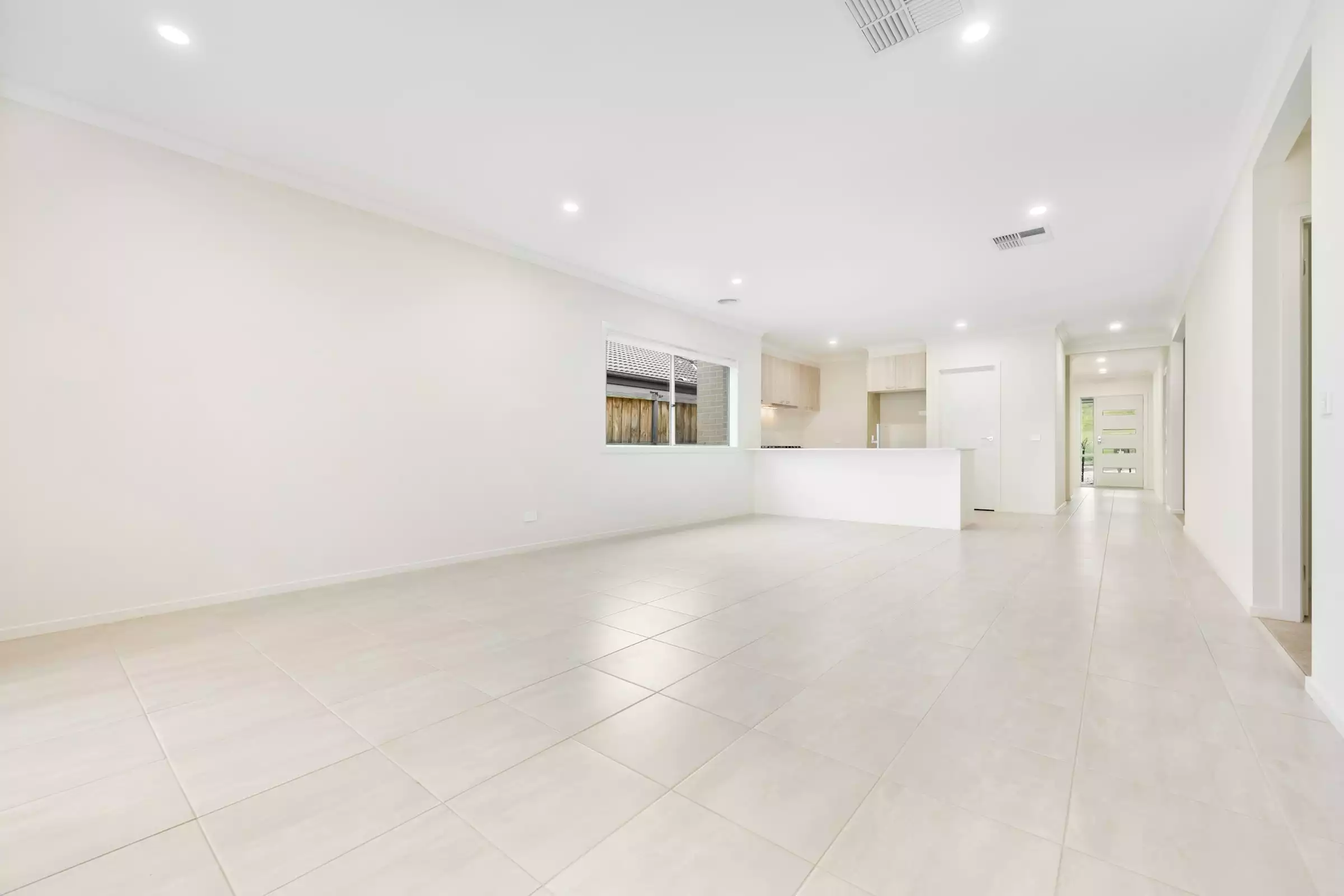 Empty open concept living and dining room before virtual staging